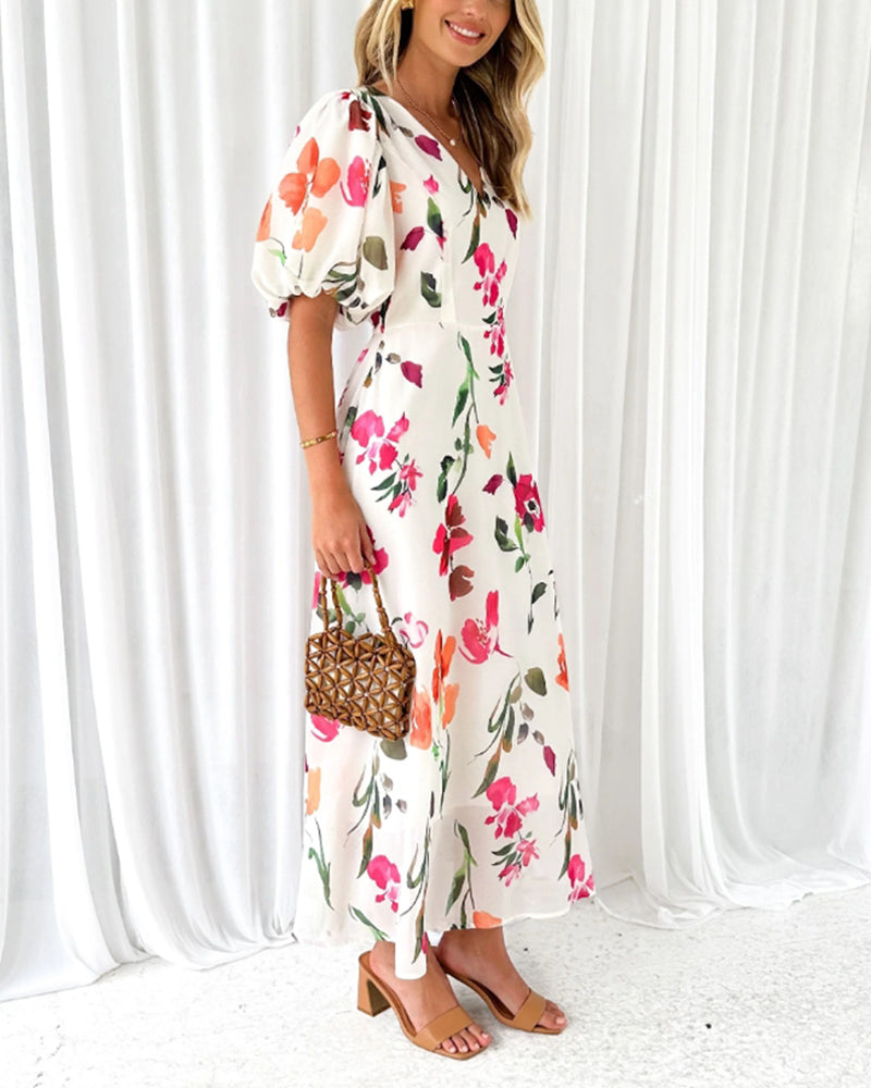 Elegant kjole med puffermer og blomsterprint