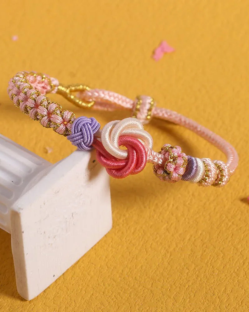Armbånd med knute av ferskenblomster