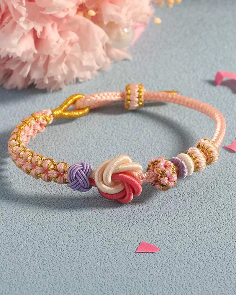 Armbånd med knute av ferskenblomster