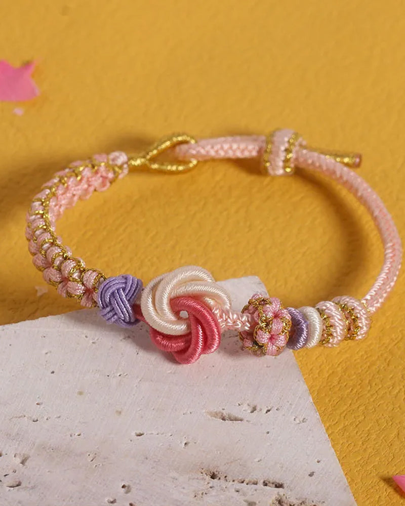 Armbånd med knute av ferskenblomster