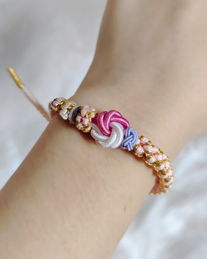 Armbånd med knute av ferskenblomster
