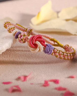 Armbånd med knute av ferskenblomster