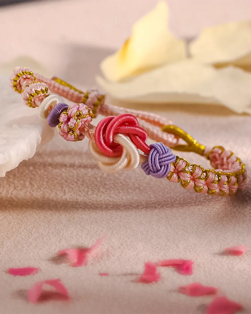 Armbånd med knute av ferskenblomster