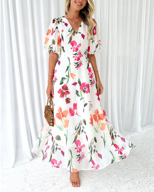Elegant kjole med puffermer og blomsterprint