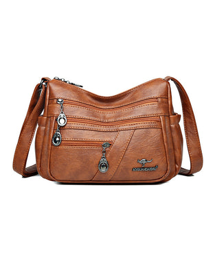Crossbody-veske i mykt skinn med multilomme