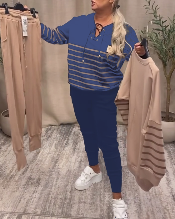 Todelt Sett Med Avslappet Stripet Sportsbukse Ved Ankelen