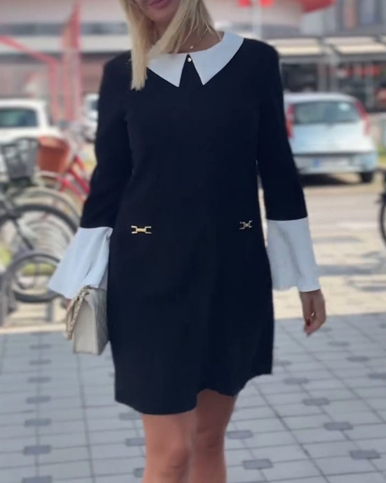 Elegant kjole med klokkeermer i kontrastfarge