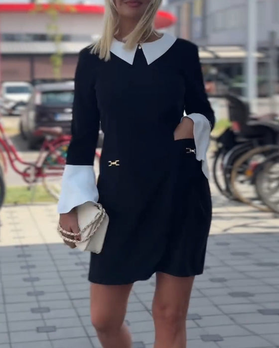 Elegant kjole med klokkeermer i kontrastfarge