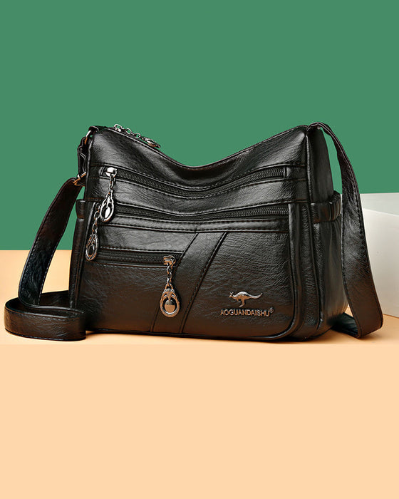 Crossbody-veske i mykt skinn med multilomme