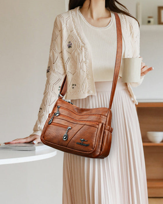 Crossbody-veske i mykt skinn med multilomme