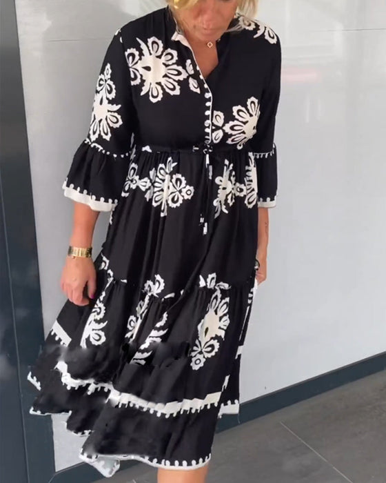 Kjole med blomstertrykk med 3/4-ermer