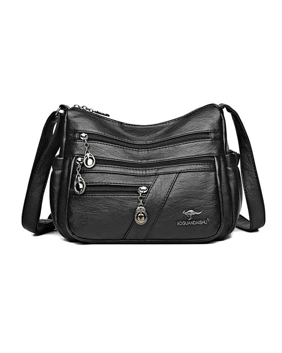 Crossbody-veske i mykt skinn med multilomme