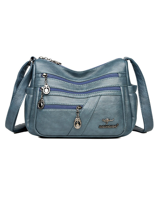 Crossbody-veske i mykt skinn med multilomme