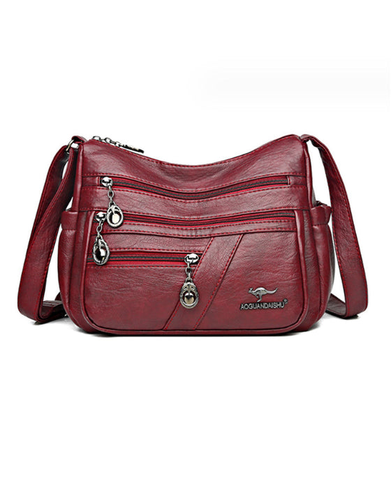 Crossbody-veske i mykt skinn med multilomme